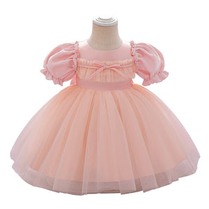 Pink and peach dress on a mannequin with a white background