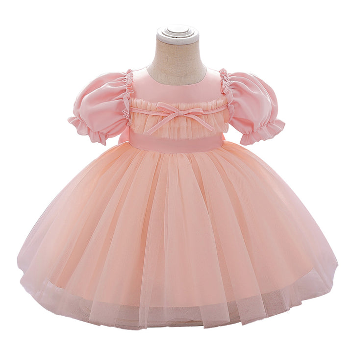 Pink and peach dress on a mannequin with a white background